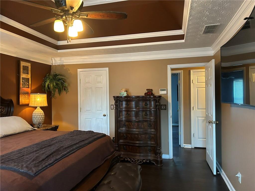 4197 Wyndham Ridge Court Northeast Buford, GA 30519 - Photo 31 of 49 a bedroom with a bed and a chandelier