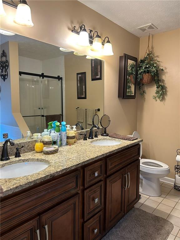 4197 Wyndham Ridge Court Northeast Buford, GA 30519 - Photo 32 of 49 a bathroom with a granite countertop double vanity and a mirror