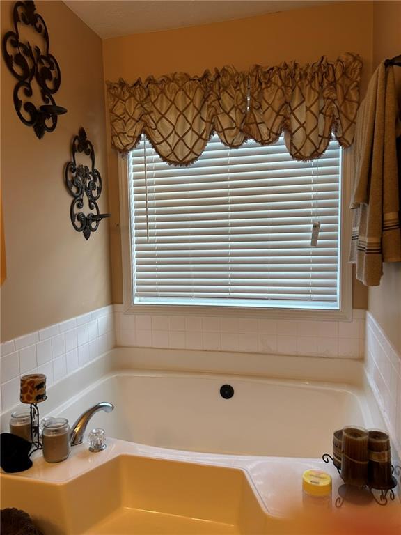 4197 Wyndham Ridge Court Northeast Buford, GA 30519 - Photo 35 of 49 a bathroom with a bathtub and a sink