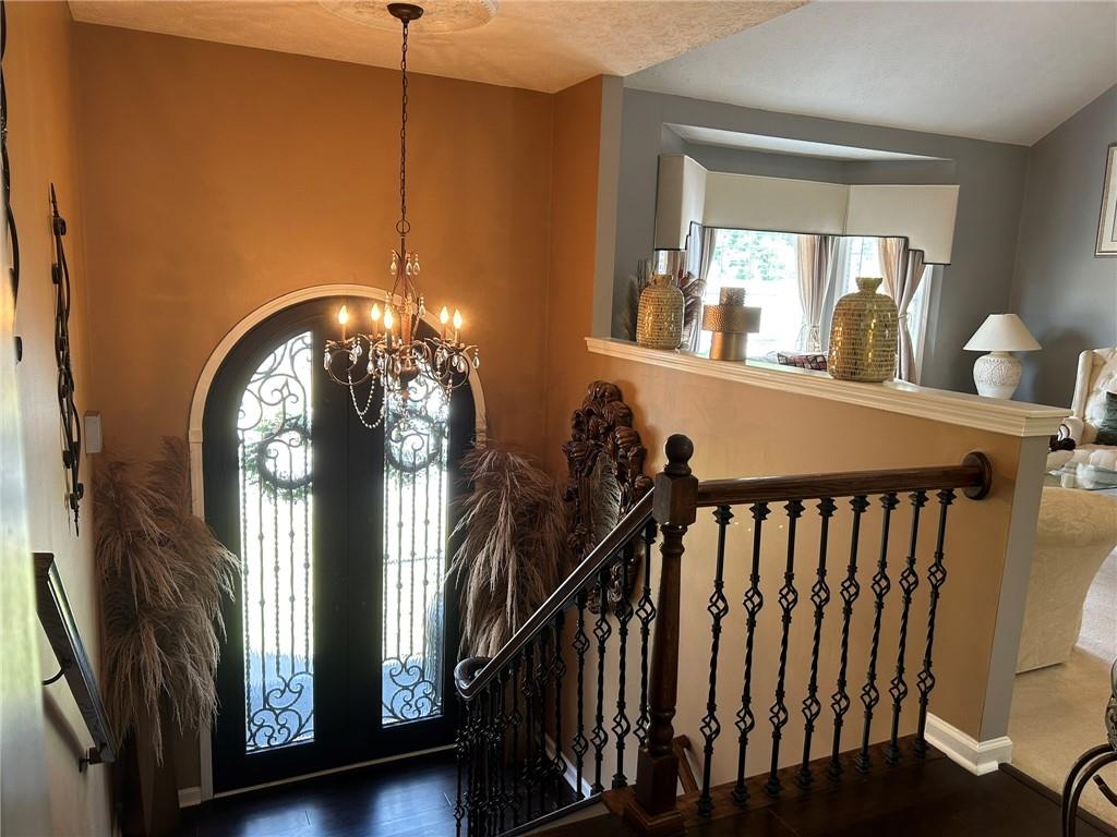 4197 Wyndham Ridge Court Northeast Buford, GA 30519 - Photo 36 of 49 a view of staircase with a large window and a chandelier