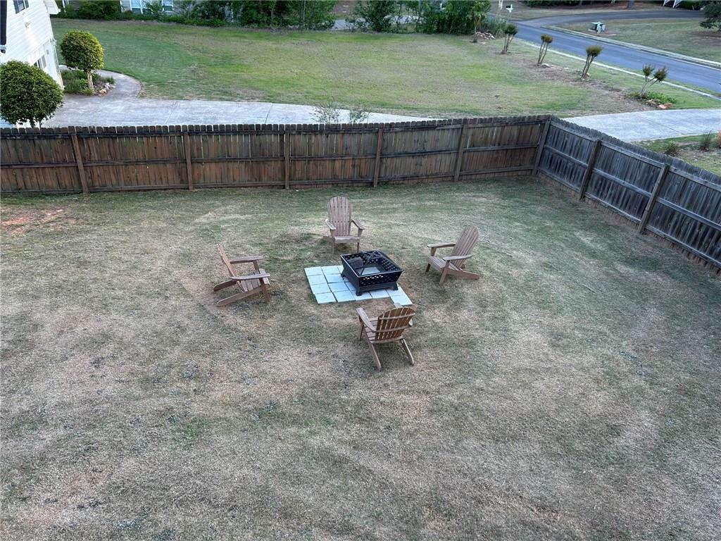 4197 Wyndham Ridge Court Northeast Buford, GA 30519 - Photo 47 of 49 a backyard of a house with a yard and outdoor seating