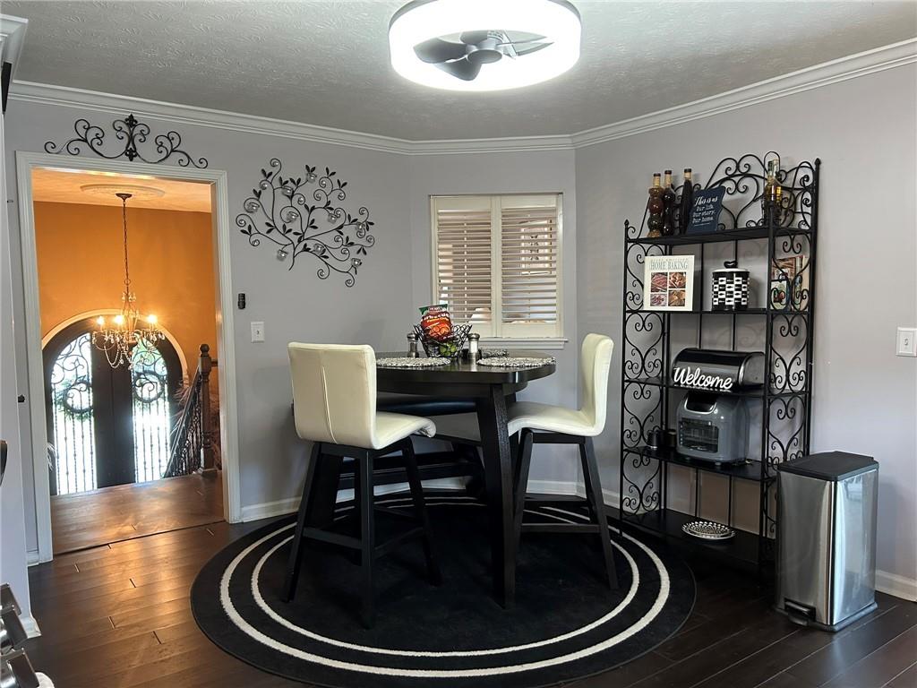 4197 Wyndham Ridge Court Northeast Buford, GA 30519 - Photo 8 of 49 a dining room with furniture and wooden floor