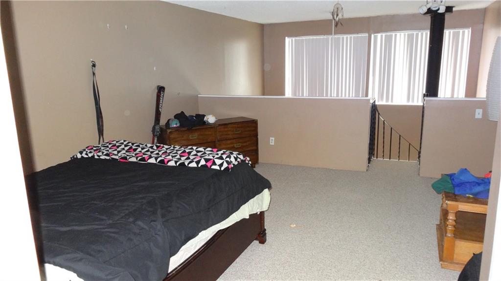 860 Copper Road, Unit 105 Copper Mountain, CO 80443 - Photo 2 of 23 a bedroom with a bed and a large window