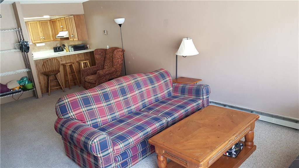 860 Copper Road, Unit 105 Copper Mountain, CO 80443 - Photo 11 of 23 a bedroom with a bed and a chandelier