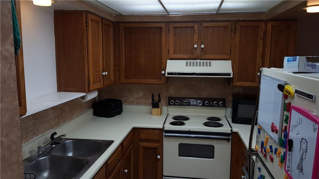 860 Copper Road, Unit 105 Copper Mountain, CO 80443 - Photo 4 of 23 a kitchen with a stove a refrigerator and cabinets