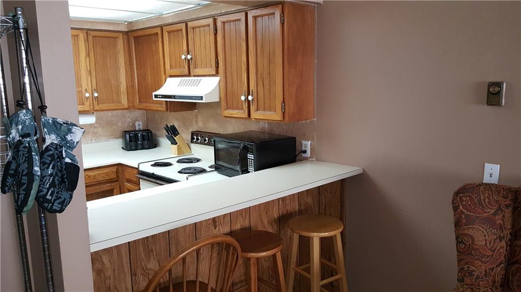 860 Copper Road, Unit 105 Copper Mountain, CO 80443 - Photo 9 of 23 a kitchen with a sink a stove and a refrigerator