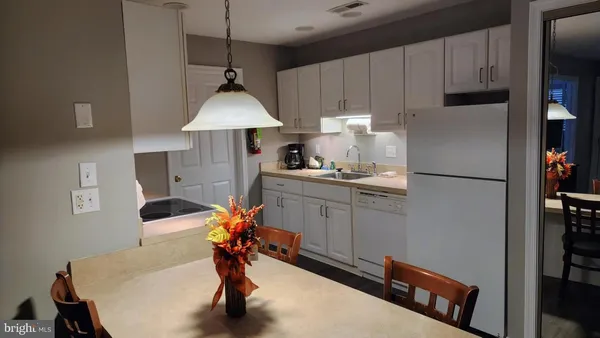 a kitchen with stainless steel appliances a sink and a refrigerator
