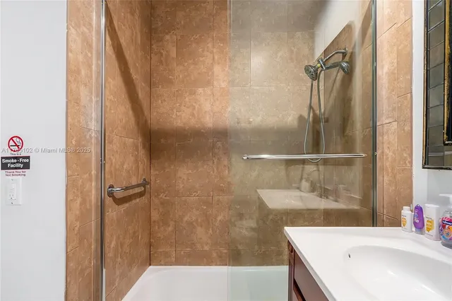 a bathroom with a sink and a mirror with toilet