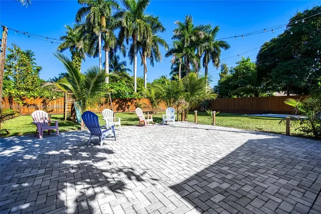 a view of a house with palm tree in the background