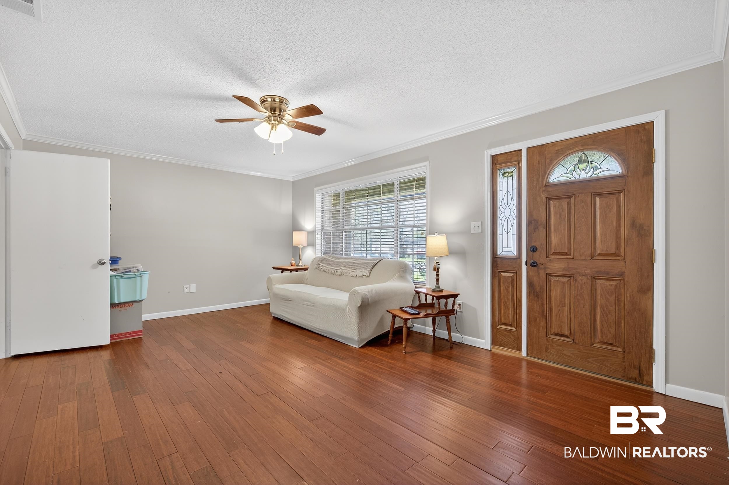 46006 Pecan Lane Bay Minette, AL 36507 - Photo 21 of 40 Living area featuring hardwood / wood-style flooring, ornamental molding, a textured ceiling, and ceiling fan