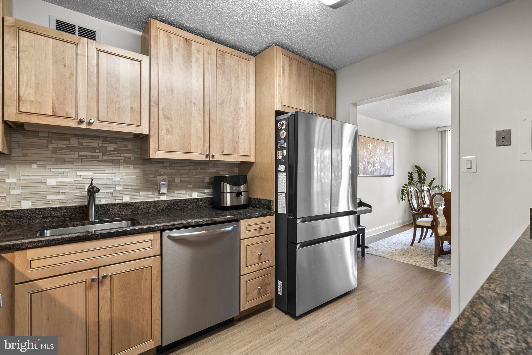 5225 Pooks Hill Road, Unit 804N Bethesda, MD 20814 - Photo 16 of 39 a kitchen with stainless steel appliances granite countertop a refrigerator sink and cabinets