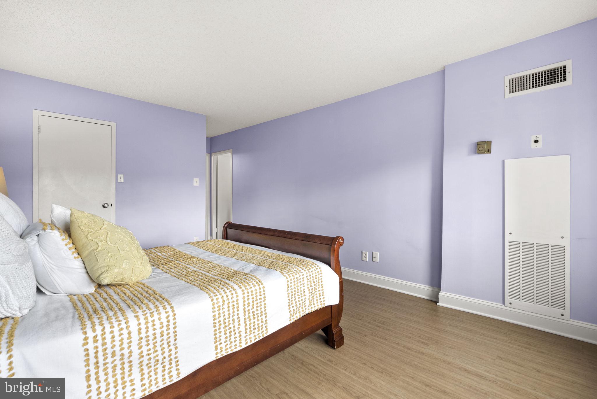 5225 Pooks Hill Road, Unit 804N Bethesda, MD 20814 - Photo 19 of 39 a bedroom with a bed and wooden floor