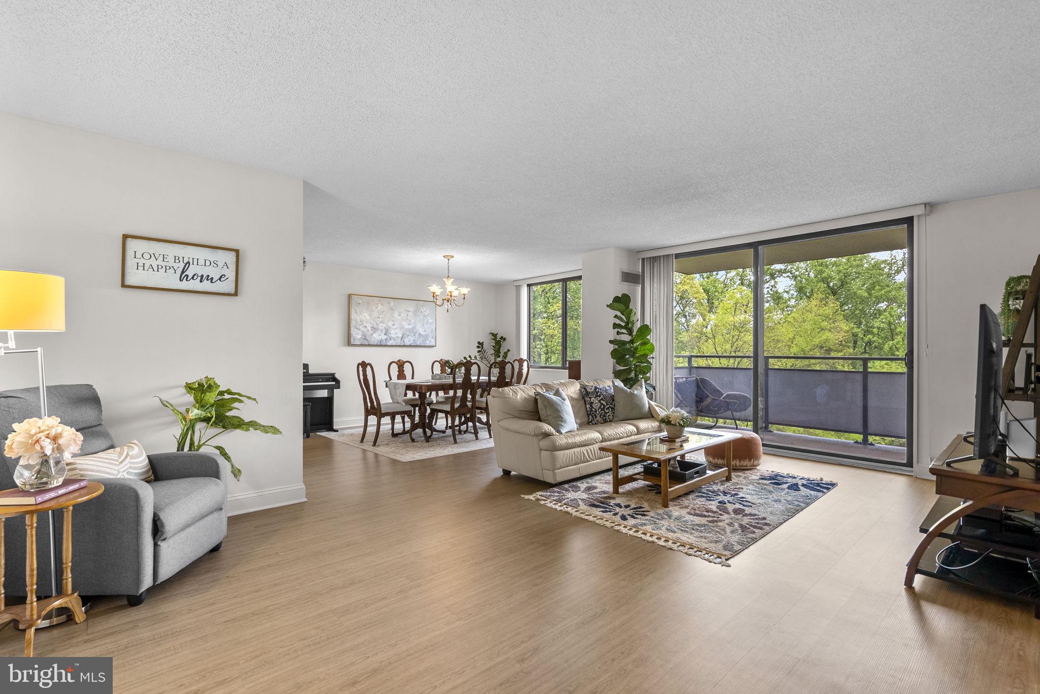 5225 Pooks Hill Road, Unit 804N Bethesda, MD 20814 - Photo 4 of 39 a living room with furniture floor to ceiling window and a flat screen tv