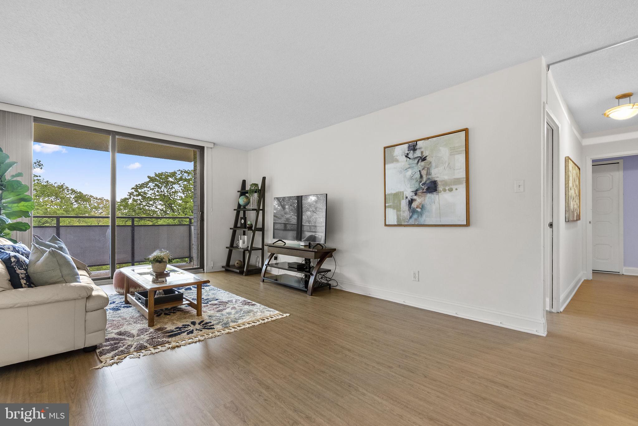 5225 Pooks Hill Road, Unit 804N Bethesda, MD 20814 - Photo 5 of 39 a living room with furniture and a large window