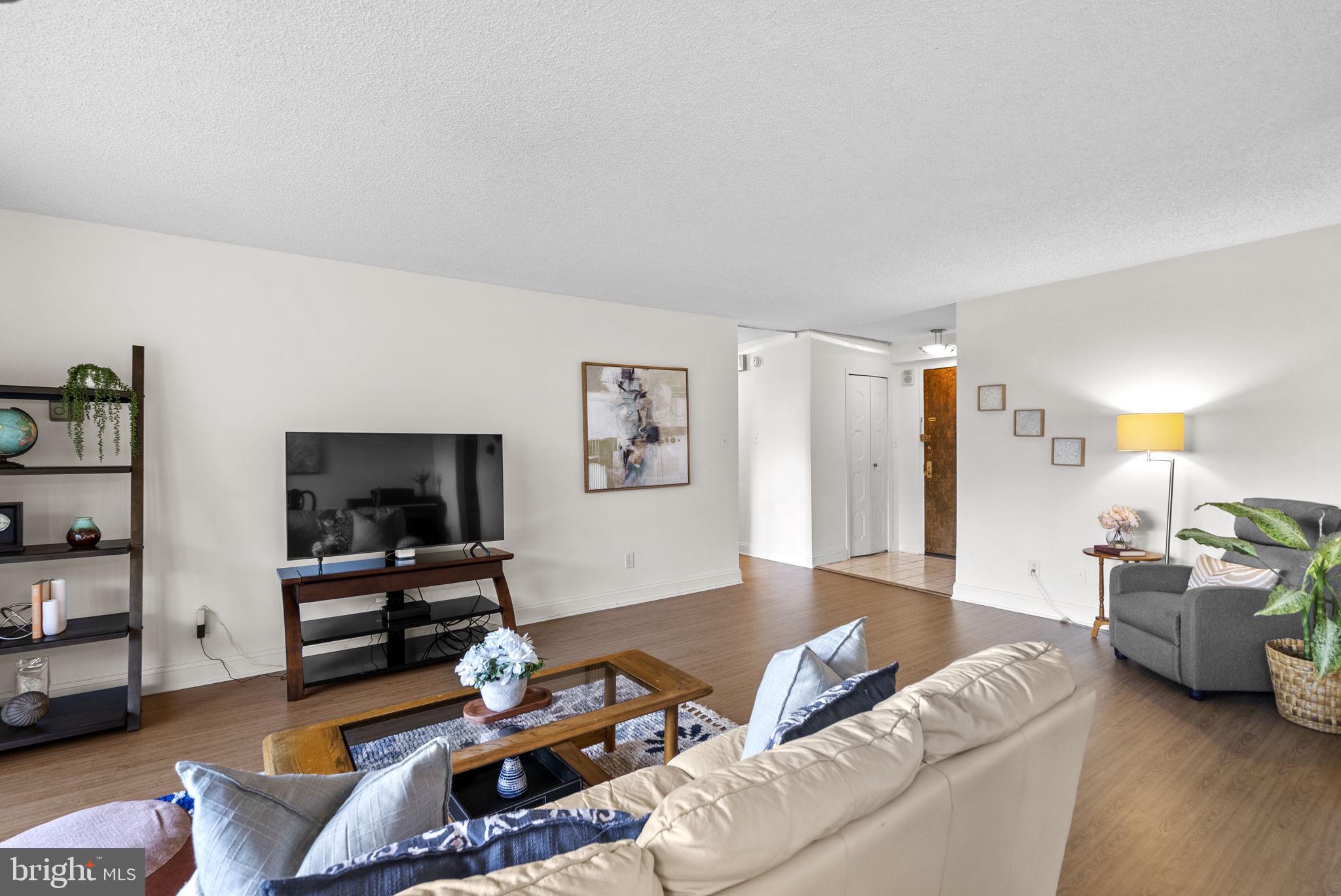5225 Pooks Hill Road, Unit 804N Bethesda, MD 20814 - Photo 6 of 39 a living room with furniture and a flat screen tv