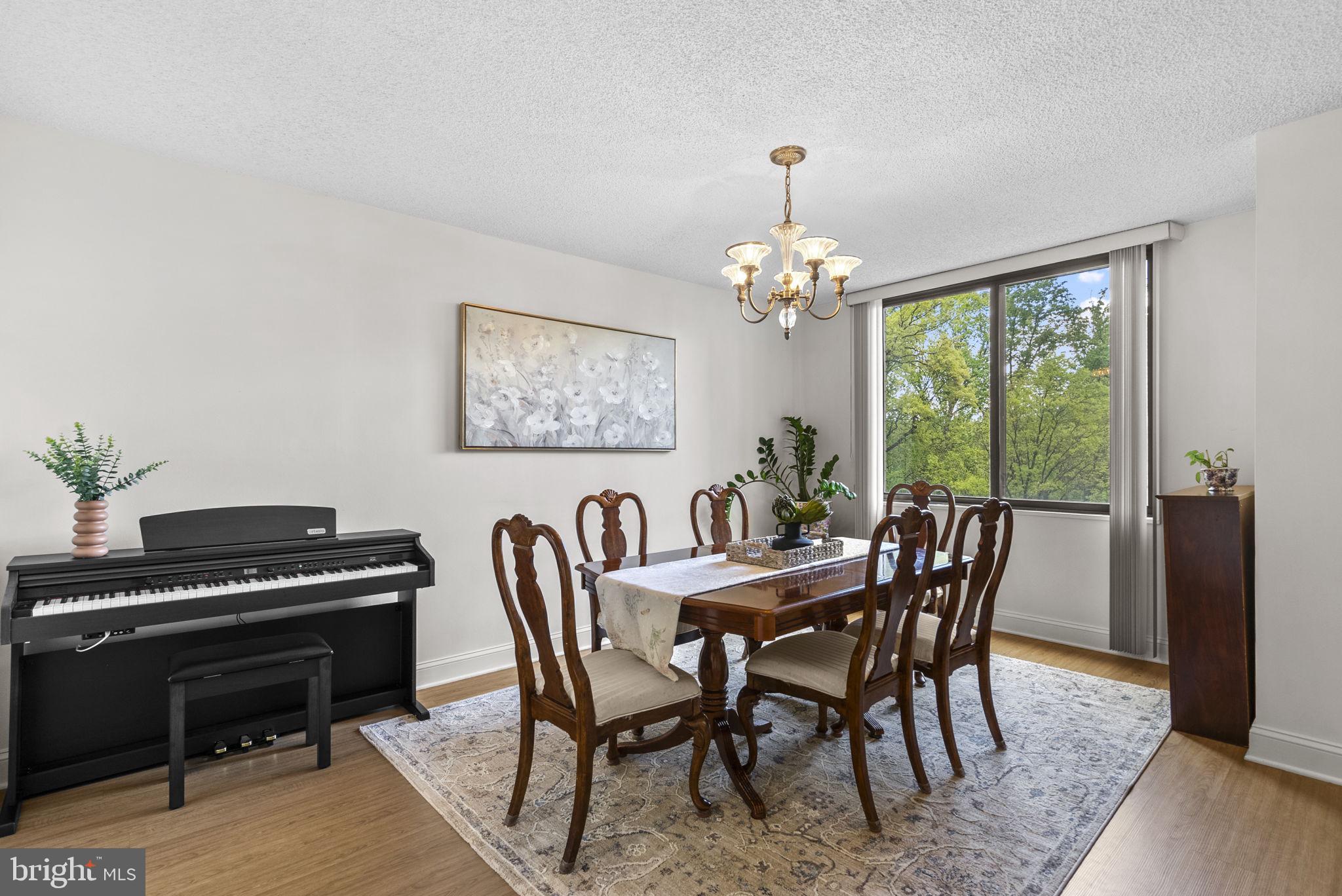 5225 Pooks Hill Road, Unit 804N Bethesda, MD 20814 - Photo 8 of 39 a view of a dining room with furniture window and wooden floor