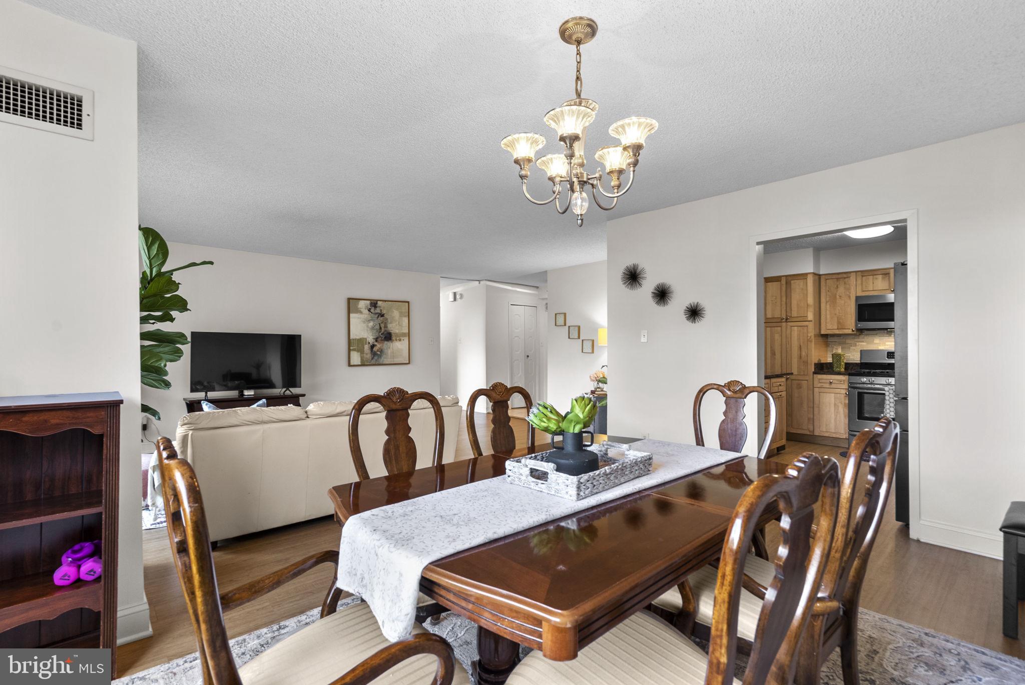 5225 Pooks Hill Road, Unit 804N Bethesda, MD 20814 - Photo 10 of 39 a living room with furniture a flat screen tv and a fireplace