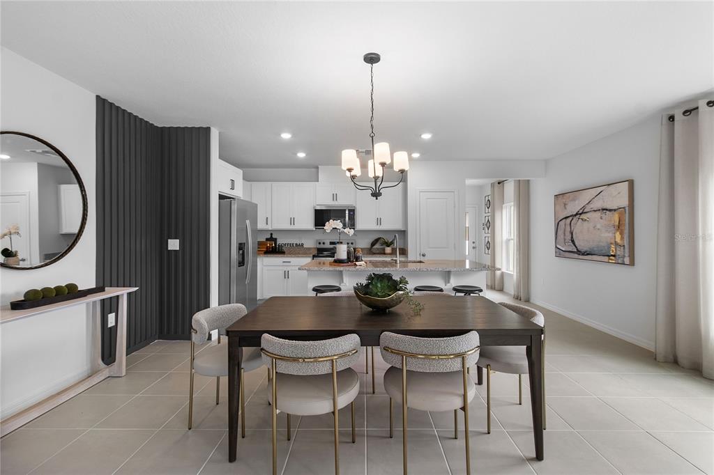 16639 Luminary Loop Clermont, FL 34714 - Photo 5 of 26 a kitchen with a dining table chairs and cabinets