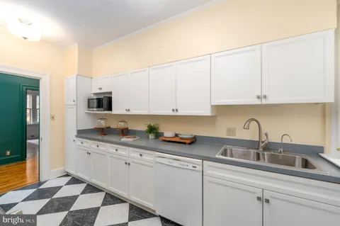 a kitchen with stainless steel appliances granite countertop a sink and cabinets