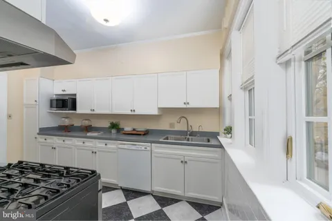 a kitchen with stainless steel appliances a sink stove and cabinets