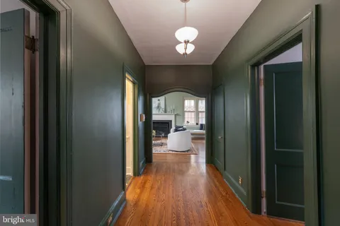 a view of a hallway with a livingroom and dining room view