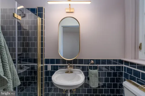 a bathroom with a sink toilet a mirror and a shower