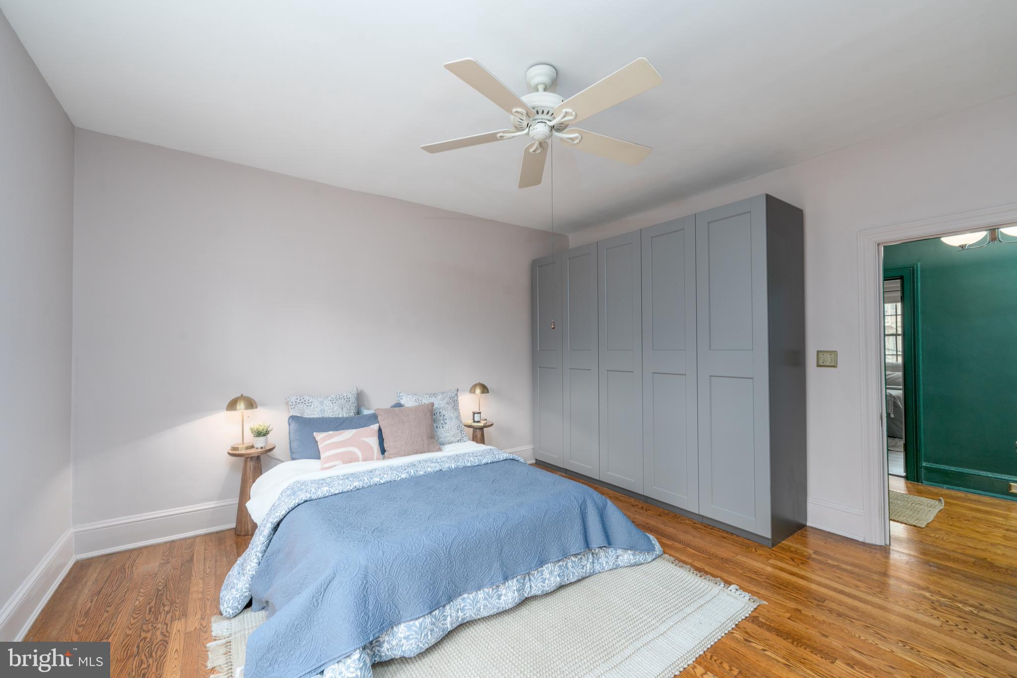 102 West 39th Street, Unit 2B Baltimore, MD 21210 - Photo 23 of 30 a bedroom with a bed and wooden floor