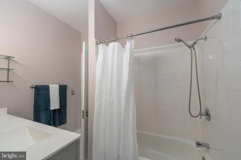 a bathroom with a shower and a bath tub
