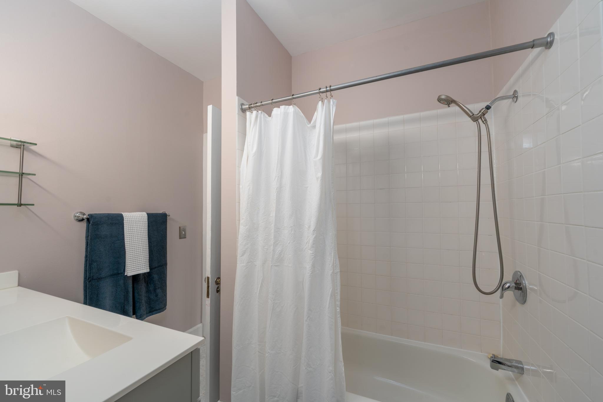 102 West 39th Street, Unit 2B Baltimore, MD 21210 - Photo 26 of 30 a bathroom with a shower and a bath tub