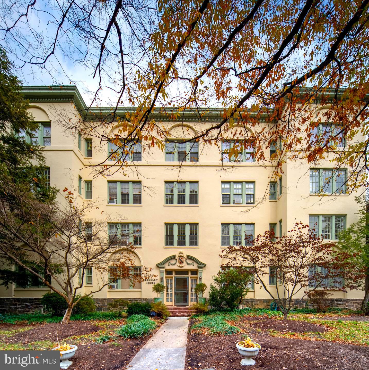 102 West 39th Street, Unit 2B Baltimore, MD 21210 - Photo 30 of 30 a front view of a residential apartment building with a yard