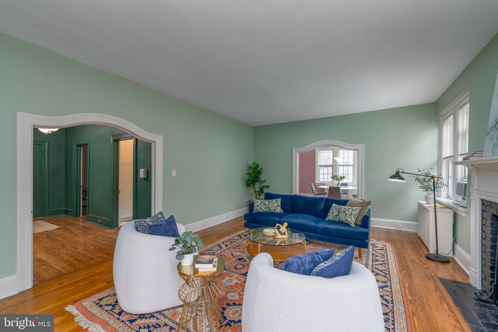 102 West 39th Street, Unit 2B Baltimore, MD 21210 - Photo 3 of 30 a living room with furniture and a wooden floor