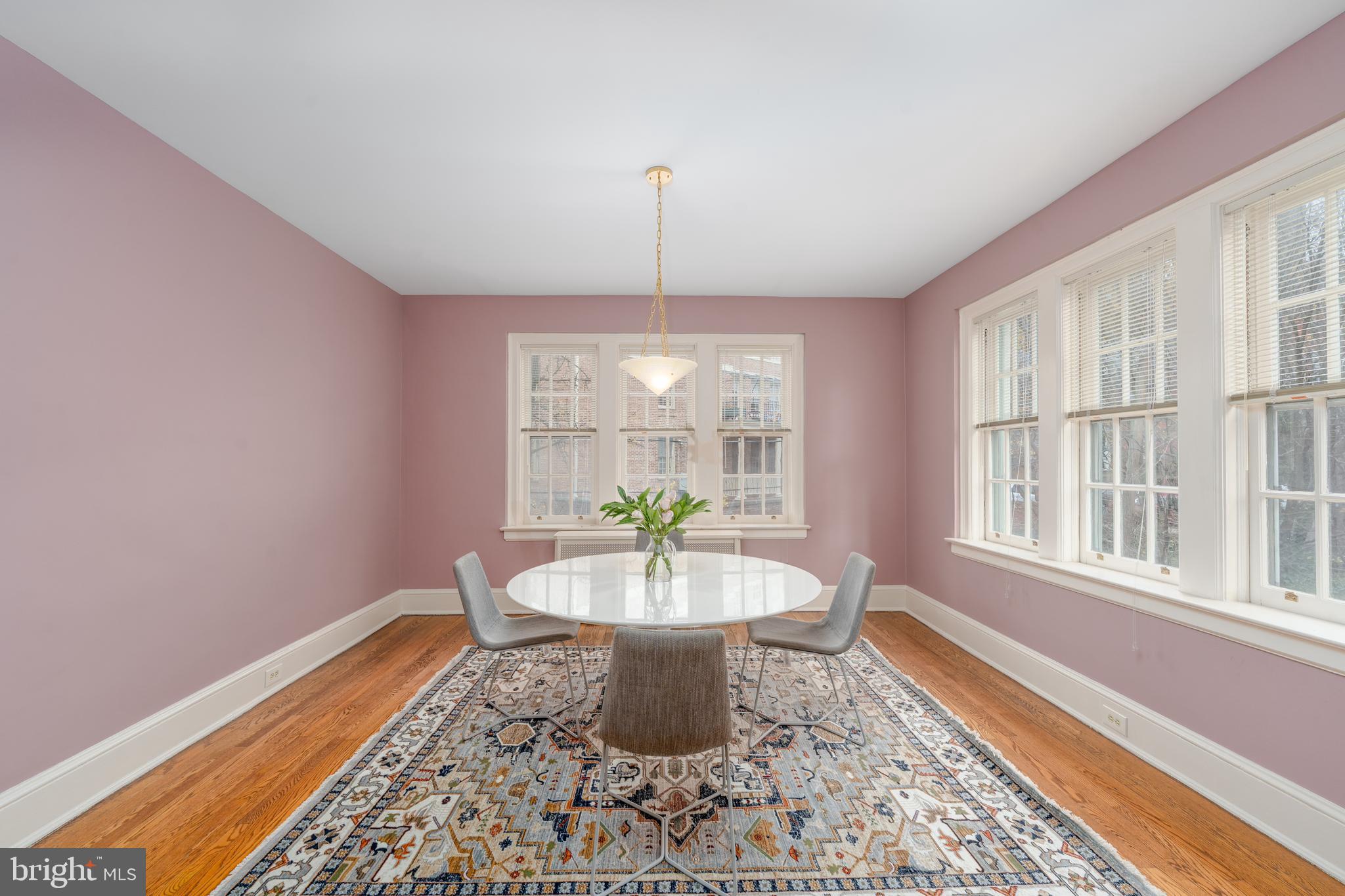 102 West 39th Street, Unit 2B Baltimore, MD 21210 - Photo 8 of 30 a dining room with furniture a rug and wooden floor