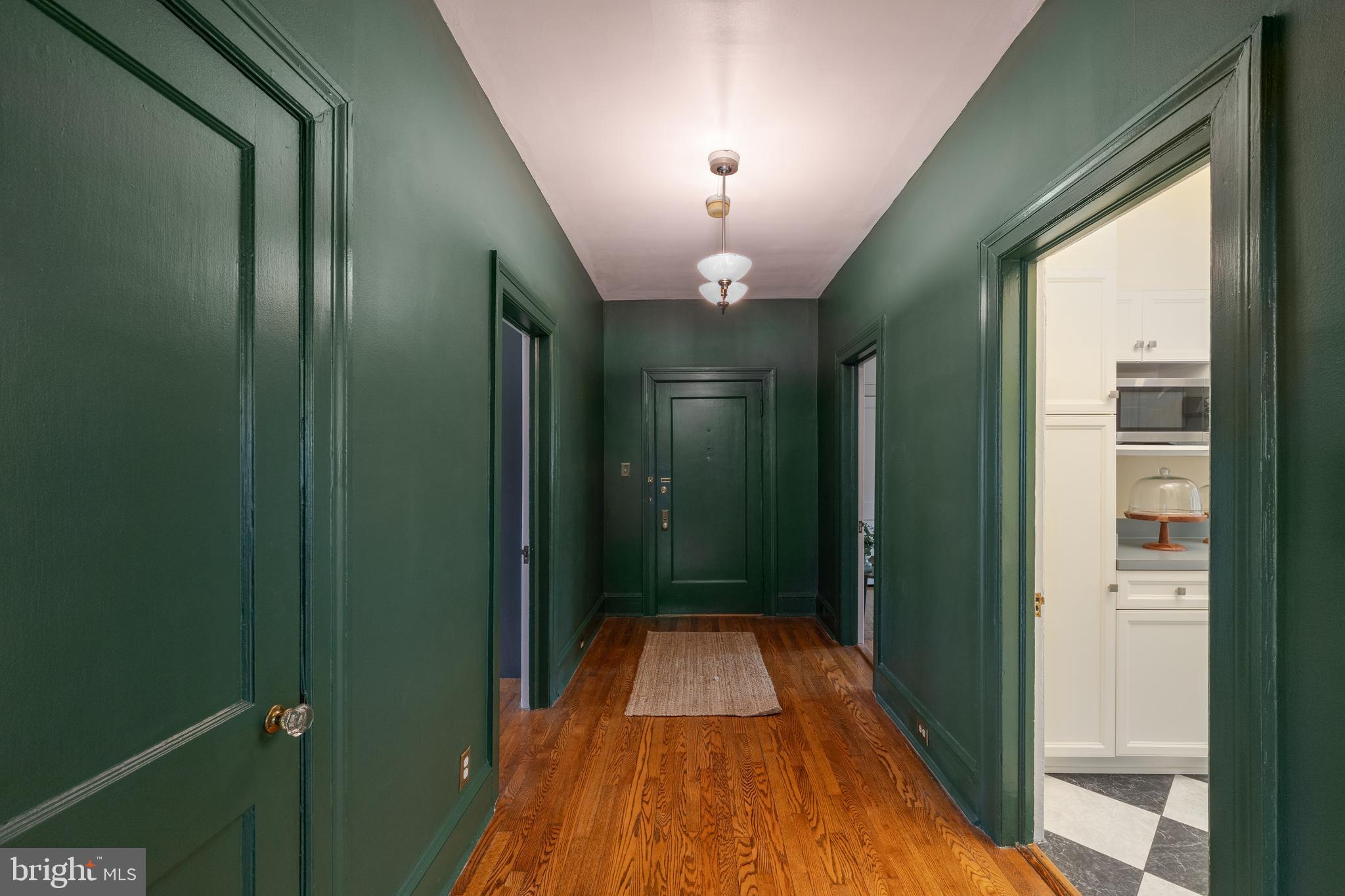 102 West 39th Street, Unit 2B Baltimore, MD 21210 - Photo 9 of 30 a view of a hallway with a chandelier