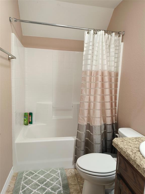 100 East Bluebonnet Drive Cresson, TX 76035 - Photo 13 of 25 Bathroom with vanity, shower / bath combo with shower curtain, and light tile patterned floors
