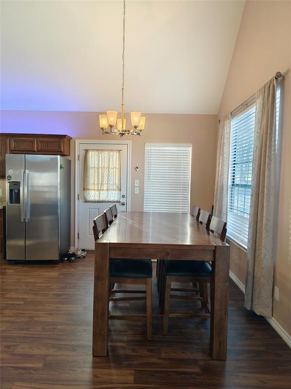 100 East Bluebonnet Drive Cresson, TX 76035 - Photo 15 of 25 Dining space with dark wood-style flooring, a chandelier, and high vaulted ceiling
