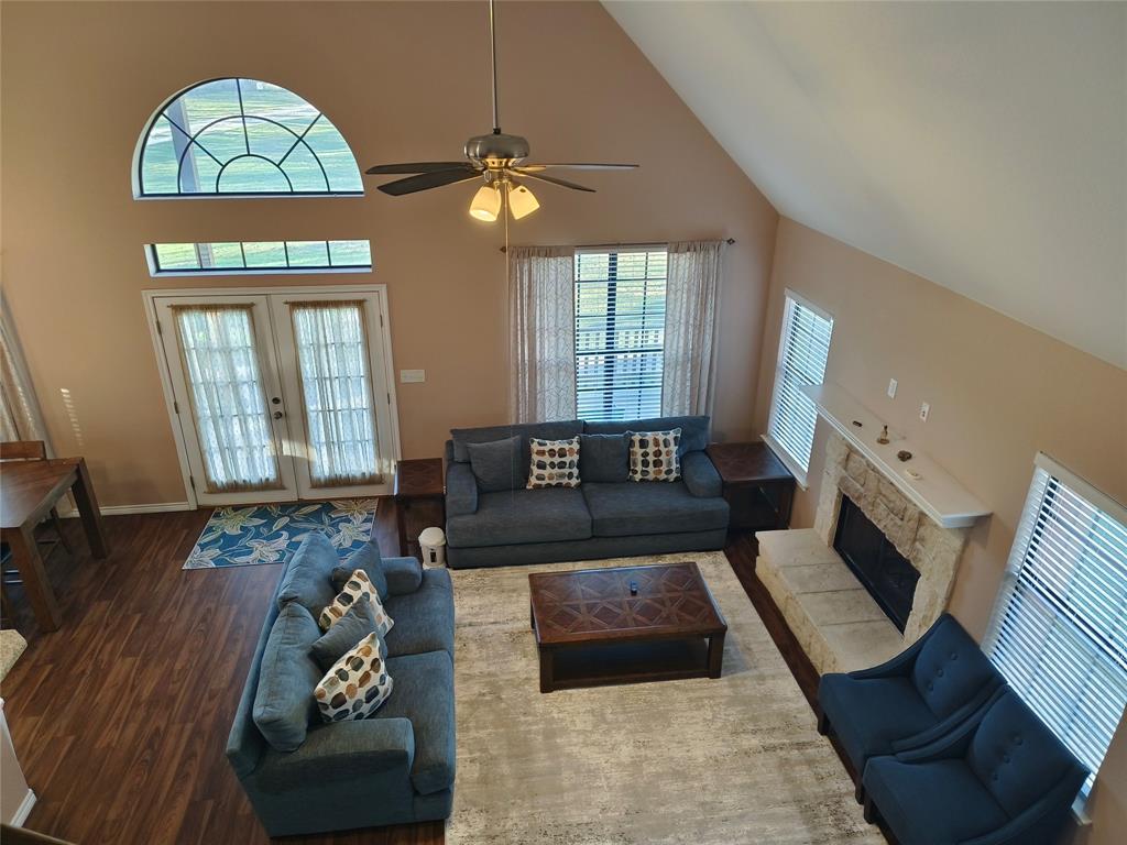 100 East Bluebonnet Drive Cresson, TX 76035 - Photo 20 of 25 Living area with high vaulted ceiling, wood finished floors, healthy amount of natural light, a ceiling fan, and french doors