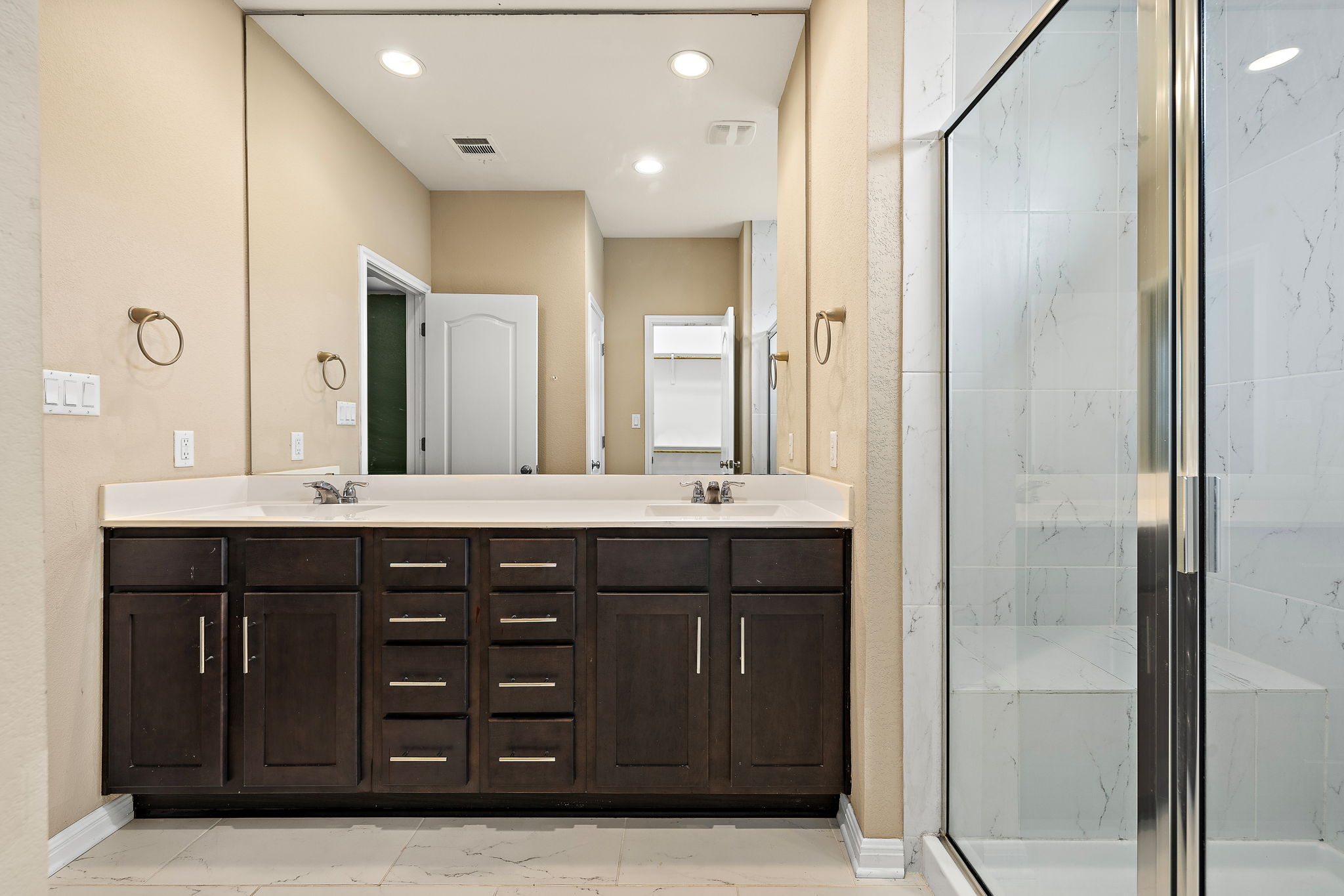 706 Coconut Grove Street Pflugerville, TX 78660 - Photo 17 of 23 This dual vanity and sleek glass shower create a spa like feel.