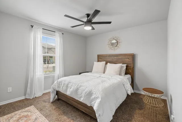 a bedroom with a bed and window