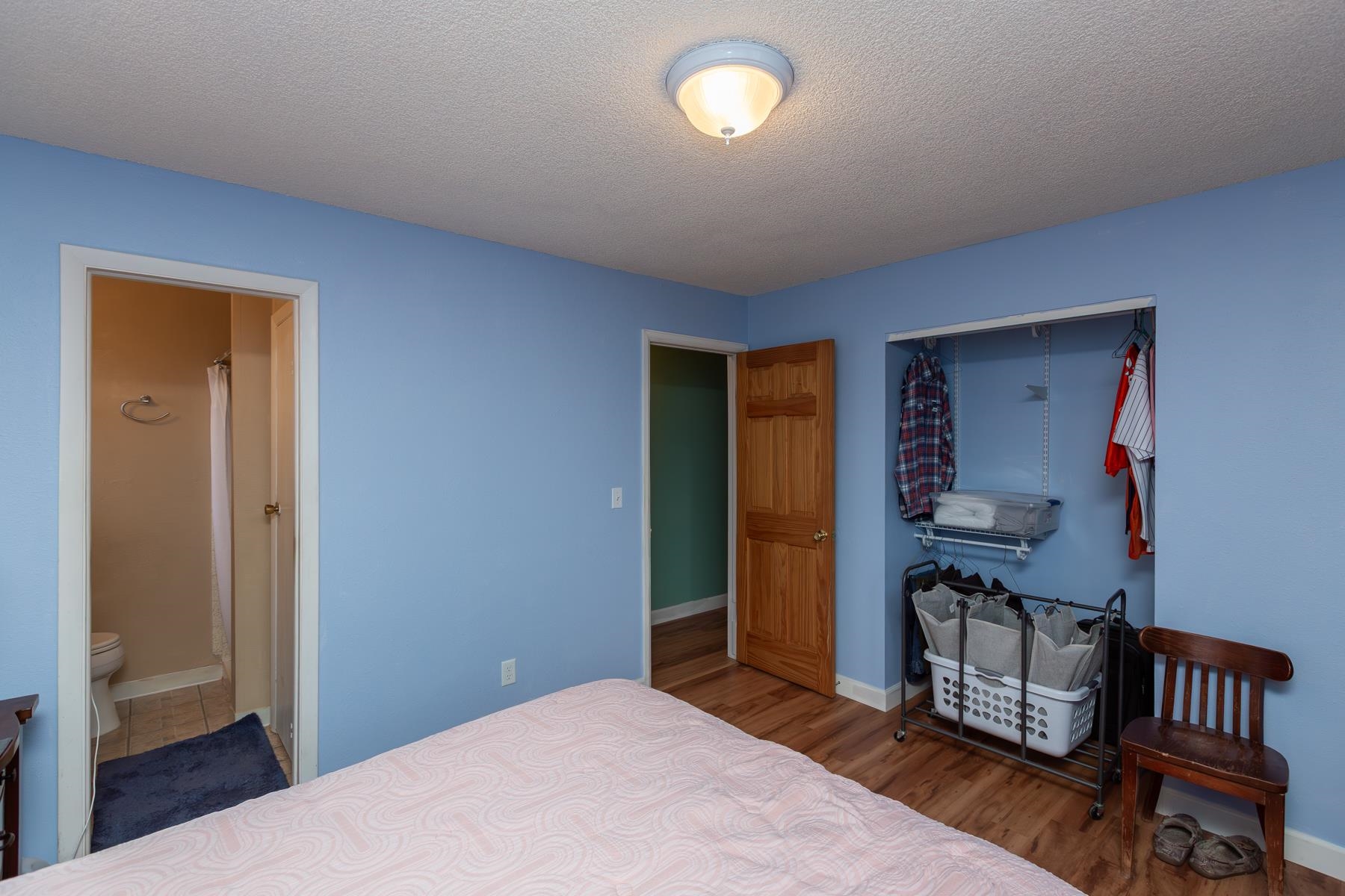 481-31 31 1/4 Road Grand Junction, CO 81504 - Photo 15 of 38 a bedroom with a bed and wooden floor