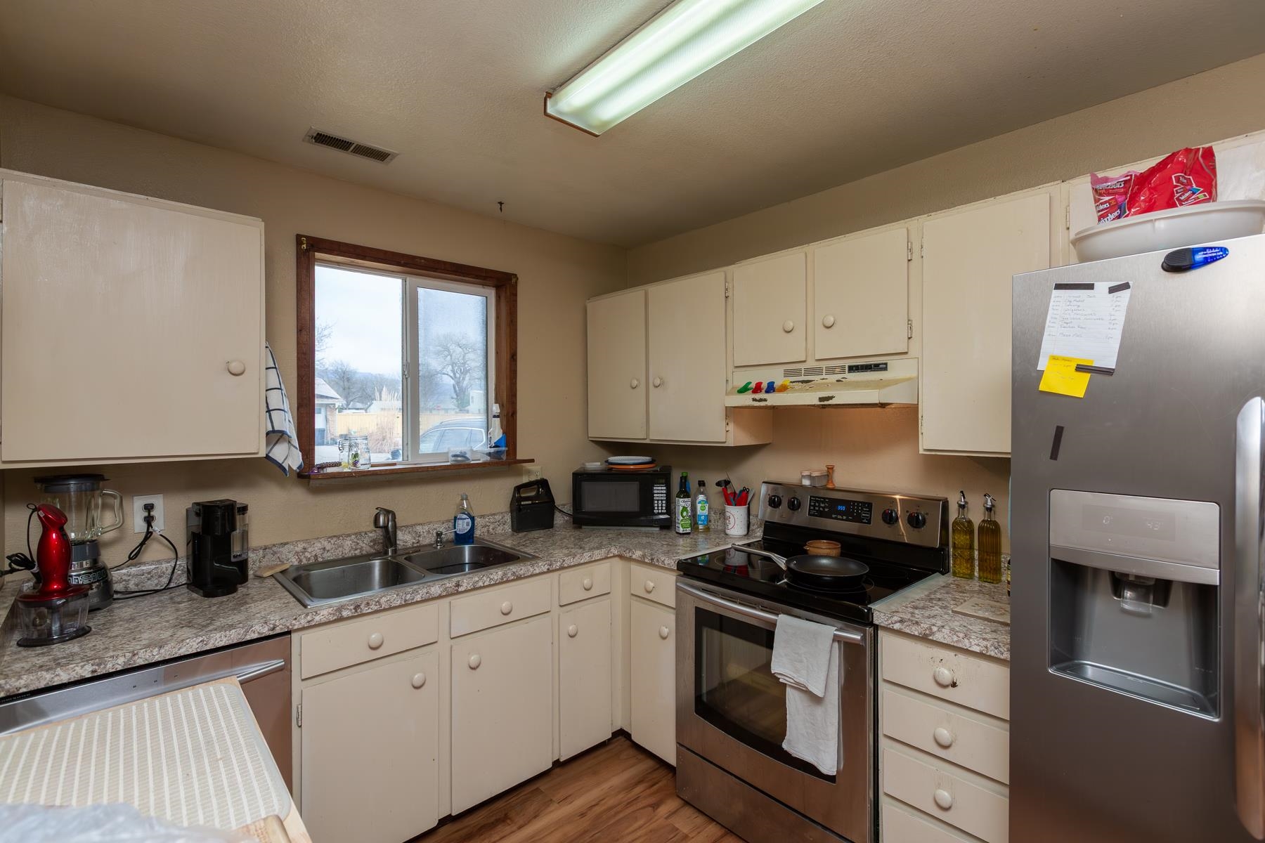 481-31 31 1/4 Road Grand Junction, CO 81504 - Photo 10 of 38 a kitchen with granite countertop a sink stainless steel appliances and cabinets