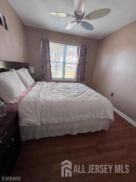 55 Edmund Street Edison, NJ 08817 - Photo 4 of 11 a bedroom with a bed and wooden floor