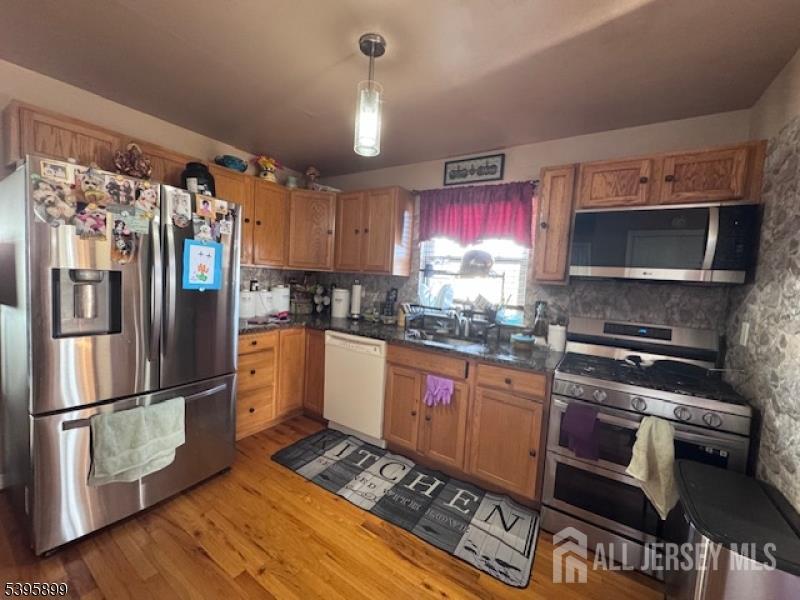 55 Edmund Street Edison, NJ 08817 - Photo 7 of 11 a kitchen with granite countertop a refrigerator stove and microwave