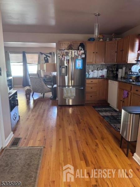 55 Edmund Street Edison, NJ 08817 - Photo 8 of 11 a kitchen with stainless steel appliances wooden floor and a refrigerator
