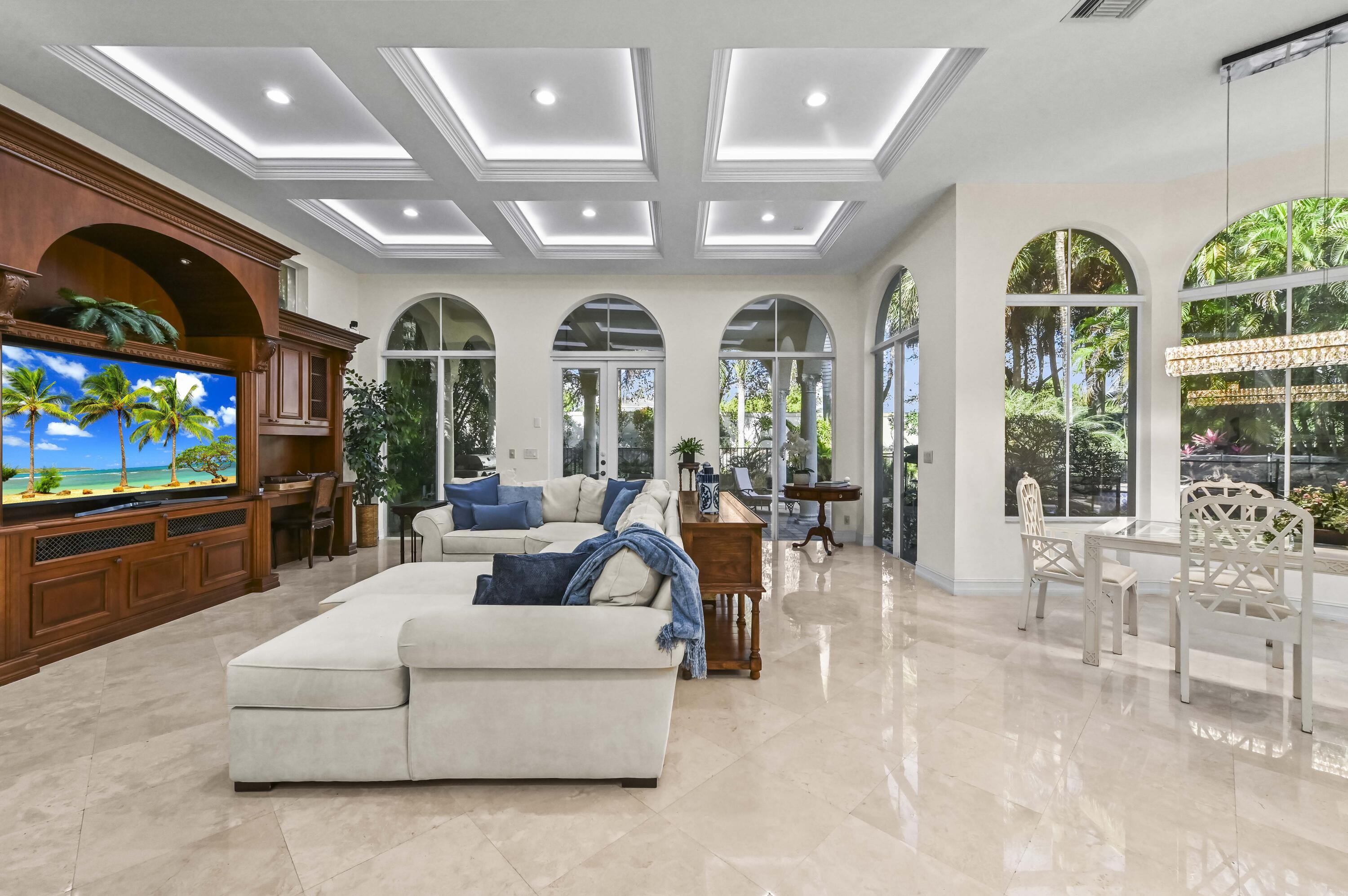 17665 Middlebrook Way Boca Raton, FL 33496 - Photo 16 of 69 a living room with furniture a flat screen tv and a floor to ceiling window