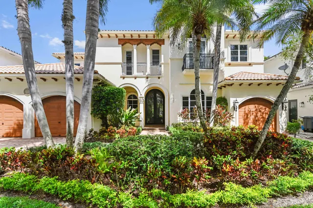 a living room with furniture a fireplace and a chandelier
