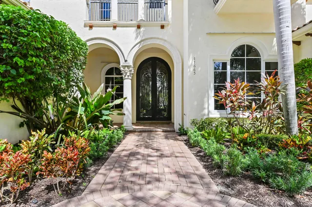 a bedroom with a bed and a flat tv screen on a dresser