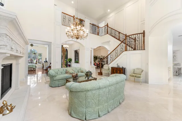 a view of a hallway with wooden floor and windows