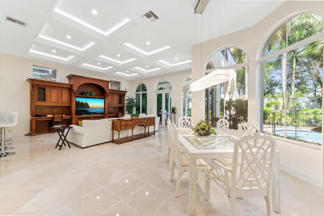 a bedroom with a large bed and a flat tv screen on dresser