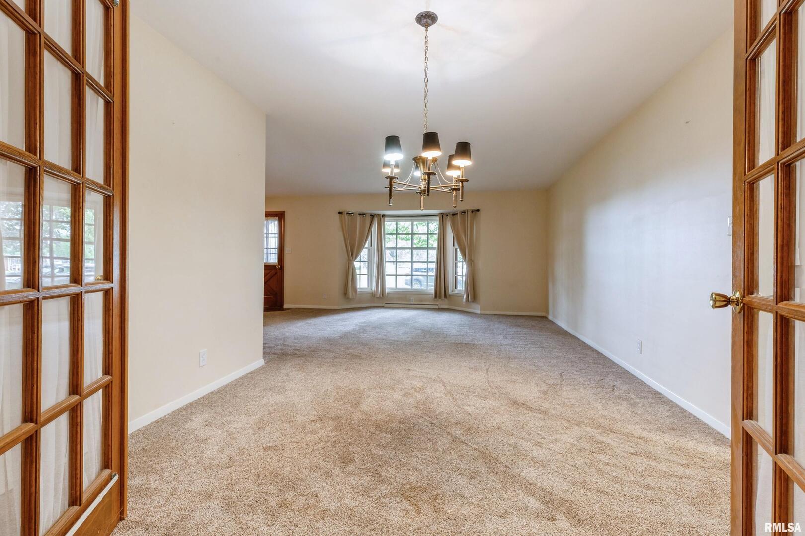 1136 Bobetta Court Clinton, IA 52732 - Photo 8 of 28 a view of a room with windows and chandelier