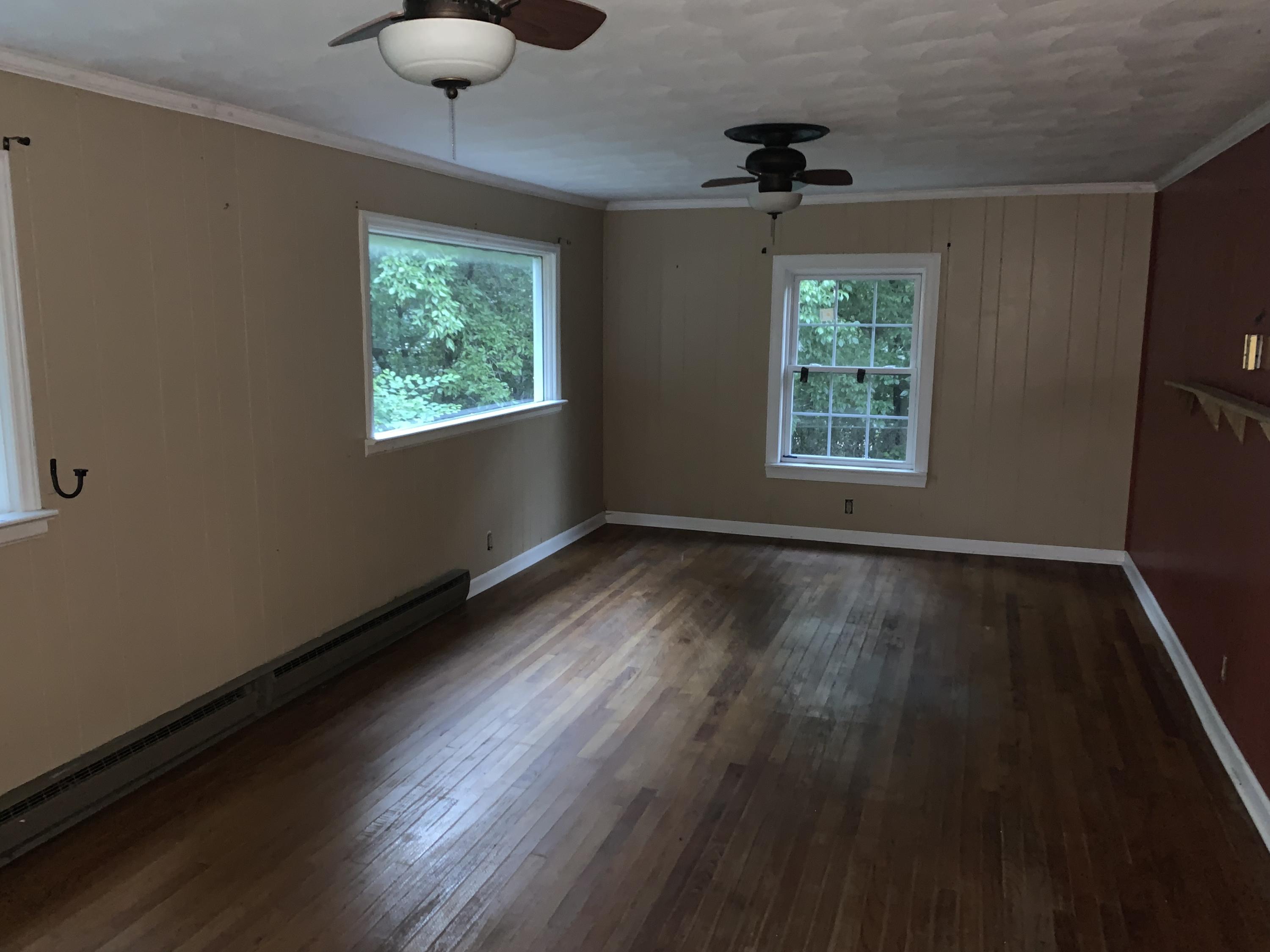 125 Dove Lane Blue Ridge, VA 24064 - Photo 3 of 18 a view of an empty room with wooden floor and a window
